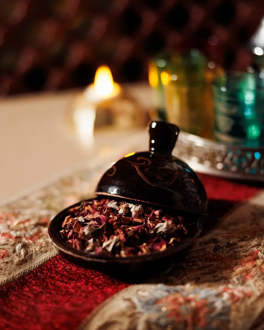 Embroidered Lavana Spa towel with rolled hand towels and a bottle of water, prepared for a private jacuzzi session at the DIFC branch